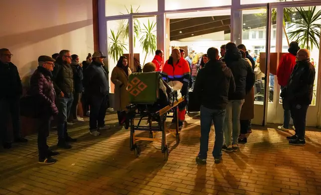 An injured person is transported to the makeshift hospital in the sports center in Adamuz, near Córdoba, southern Spain, Monday, Jan. 19, 2026, after a high-speed train derailed and collided with another train. (Francisco J. Olmo/Europa Press via AP)