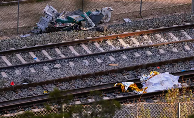 Pieces of a crashed train are photographed at the site of a train collision in Adamuz, southern Spain, Monday, Jan. 19, 2026. (AP Photo/Manu Fernandez)