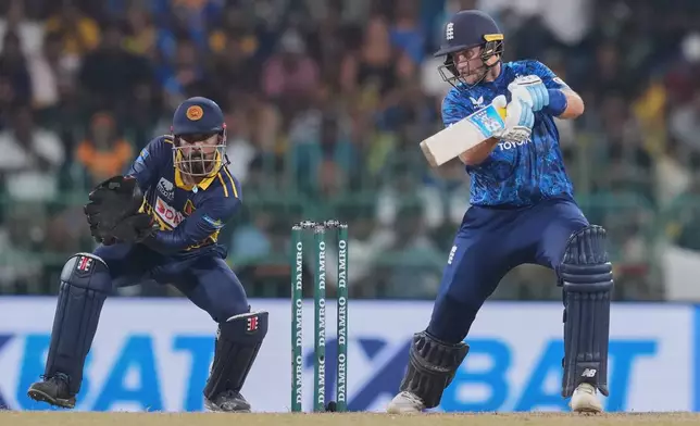 England's Joe Root plays a shot as Sri Lanka's Kusal Mendis watches during the second ODI cricket match between England and Sri Lanka in Colombo, Sri Lanka, Saturday, Jan. 24, 2026. (AP Photo/Eranga Jayawardena)
