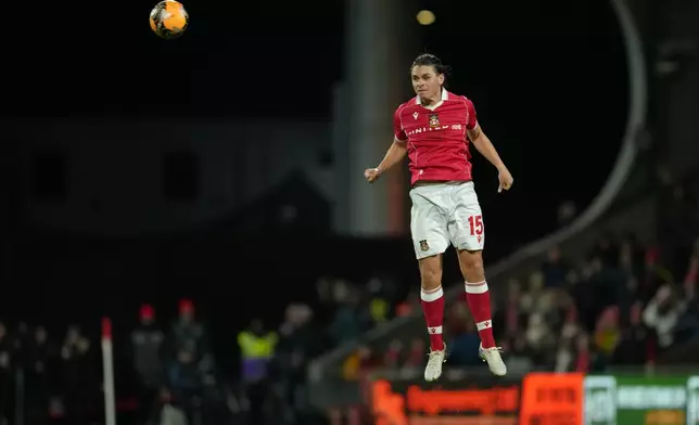 Wrexham's George Dobson heads the ball during the English FA Cup third round soccer match between Wrexham and Nottingham Forest in Wrexham, Wales, Friday, Jan. 9, 2026. (AP Photo/Jon Super)