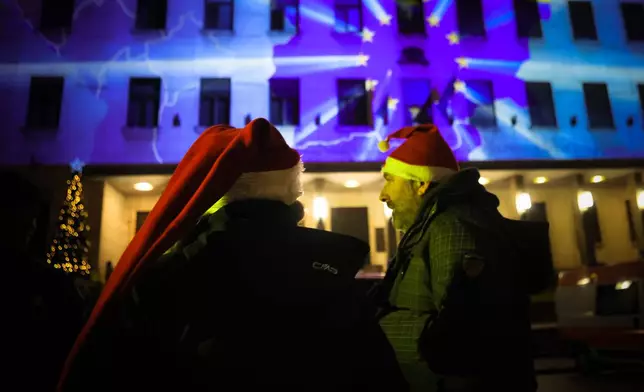 A map of Bulgaria with the EU symbol is projected on the Bulgarian National Bank as people celebrate New Year's Eve and Bulgaria's adoption of the euro in Sofia, Bulgaria, Thursday Jan. 1, 2026. (AP Photo/Valentina Petrova)