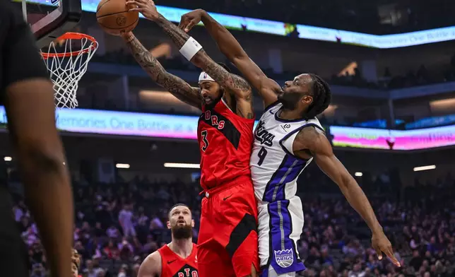Toronto Raptors forward Brandon Ingram (3) grabs the rebound against Sacramento Kings forward Precious Achiuwa (9) during the first half of an NBA basketball game, Wednesday, Jan. 21, 2026, in Sacramento, Calif. (AP Photo/Justine Willard)