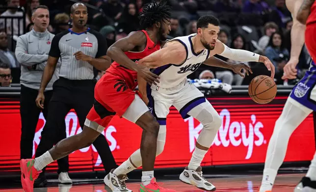 Toronto Raptors guard Immanuel Quickley (5) knocks the ball away from Sacramento Kings guard Zach LaVine (8) during the first half of an NBA basketball game, Wednesday, Jan. 21, 2026, in Sacramento, Calif. (AP Photo/Justine Willard)