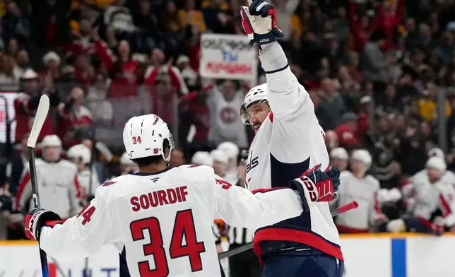Washington Capitals left wing Alex Ovechkin, right, celebrates with Justin Sourdif (34) after scoring against the Nashville Predators during the first period of an NHL hockey game Sunday, Jan. 11, 2026, in Nashville, Tenn. (AP Photo/Mark Humphrey)