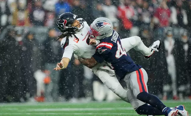 New England Patriots linebacker K'lavon Chaisson, right, hits Houston Texans quarterback C.J. Stroud during the first half of an NFL divisional playoff football game, Sunday, Jan. 18, 2026, in Foxborough, Mass. (AP Photo/Robert F. Bukaty)