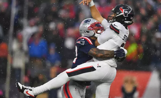 New England Patriots linebacker K'lavon Chaisson, left, hits Houston Texans quarterback C.J. Stroud during the first half of an NFL divisional playoff football game, Sunday, Jan. 18, 2026, in Foxborough, Mass. (AP Photo/Steven Senne)