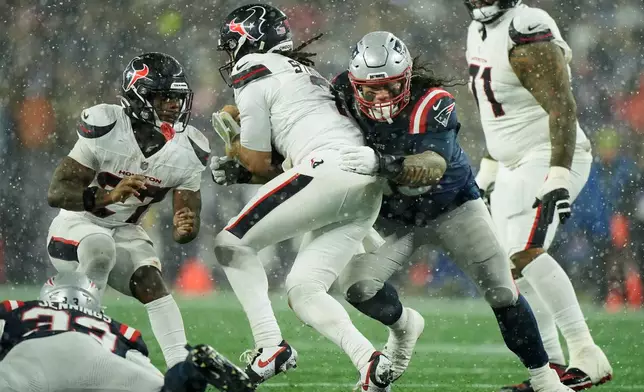 New England Patriots defensive tackle Khyiris Tonga, middle right, sacks Houston Texans quarterback C.J. Stroud during the second half of an NFL divisional playoff football game, Sunday, Jan. 18, 2026, in Foxborough, Mass. (AP Photo/Robert F. Bukaty)