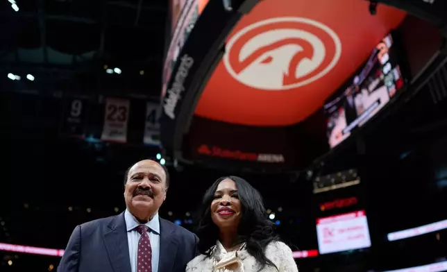 Martin Luther King III, and his wife Arndrea Waters King smile during the second half of an NBA basketball game between the Atlanta Hawks and the Milwaukee Bucks, Monday, Jan. 19, 2026, in Atlanta. (AP Photo/Mike Stewart)