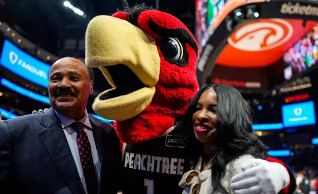 Martin Luther King III, and his wife Arndrea Waters King pose for a photo during the second half of an NBA basketball game between the Atlanta Hawks and the Milwaukee Bucks, Monday, Jan. 19, 2026, in Atlanta. (AP Photo/Mike Stewart)