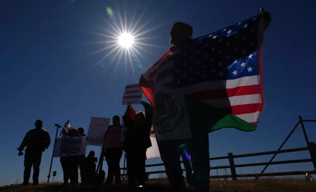 Protesters gather outside the South Texas Family Residential Center detention facility where Liam Ramos and his father are being detained in Dilley, Texas, Wednesday, Jan. 28, 2026. (AP Photo/Eric Gay)
