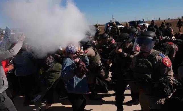 Pepper spray is used by Texas troopers to disperse protesters outside the South Texas Family Residential Center detention facility where Liam Ramos and his father are being detained in Dilley, Texas, Wednesday, Jan. 28, 2026. (AP Photo/Eric Gay)