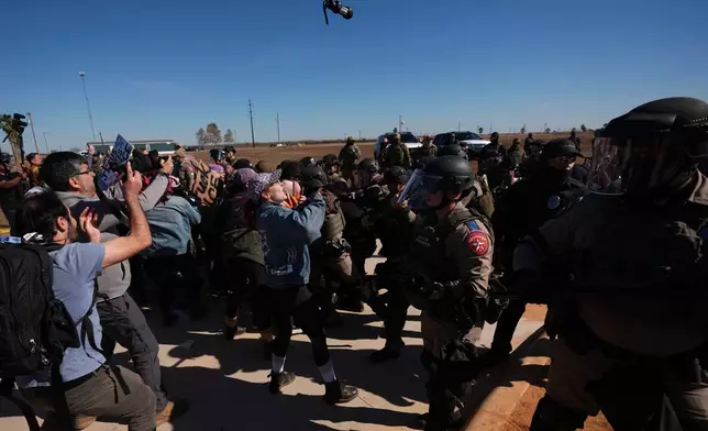 A canister of pepper spray launched by Texas troopers flies towards protesters outside the South Texas Family Residential Center detention facility where Liam Ramos and his father are being detained in Dilley, Texas, Wednesday, Jan. 28, 2026. (AP Photo/Eric Gay)