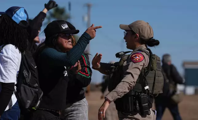 Protesters yell at a Texas state trooper outside the South Texas Family Residential Center detention facility where Liam Ramos and his father are being detained in Dilley, Texas, Wednesday, Jan. 28, 2026. (AP Photo/Eric Gay)