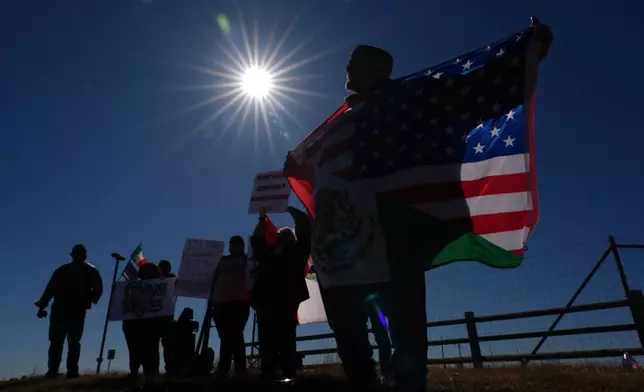 Protesters gather outside the South Texas Family Residential Center detention facility where Liam Ramos and his father are being detained in Dilley, Texas, Wednesday, Jan. 28, 2026. (AP Photo/Eric Gay)