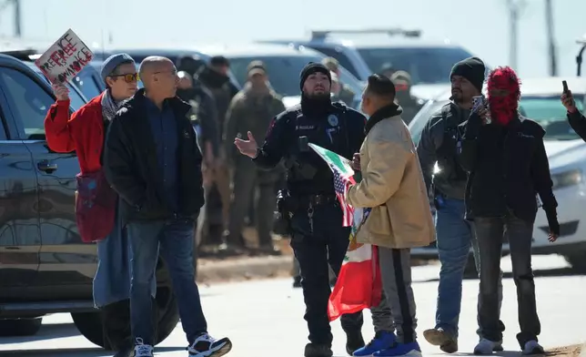 Protesters are pushed back as they gather outside the South Texas Family Residential Center detention facility where Liam Ramos and his father are being detained in Dilley, Texas, Wednesday, Jan. 28, 2026. (AP Photo/Eric Gay)