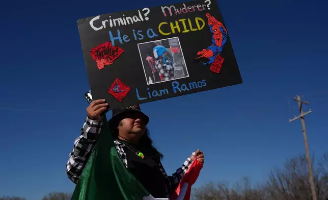 Protesters gather outside the South Texas Family Residential Center detention facility where Liam Ramos and his father are being detained in Dilley, Texas, Wednesday, Jan. 28, 2026. (AP Photo/Eric Gay)