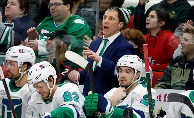 Carolina Hurricanes head coach Rod Brind'Amour, center top, protests a call during the third period of an NHL hockey game against the Utah Mammoth in Raleigh, N.C., Thursday, Jan. 29, 2026. (AP Photo/Karl DeBlaker)