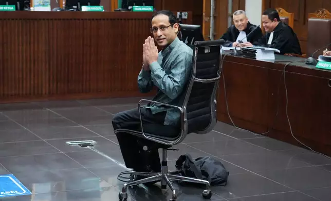 Nadiem Anwar Makarim, the co-founder of Indonesia's payments platform and ride hailing company Gojek and former education minister, reacts as he sits on the defendant's chair before the start of his first trial hearing at the Corruption Court in Jakarta, Indonesia, Monday, Jan. 5, 2026. (AP Photo/Tatan Syuflana)