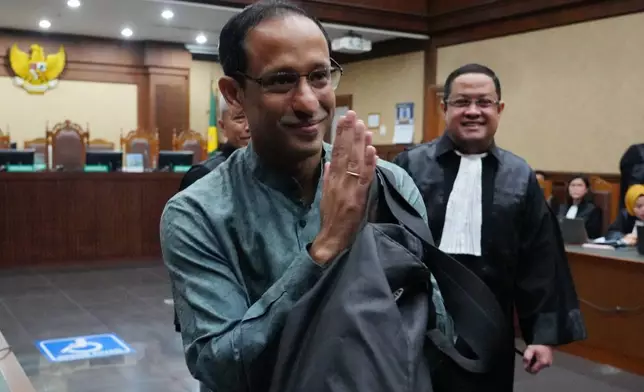 Nadiem Anwar Makarim, the co-founder of Indonesia's payments platform and ride hailing company Gojek and former education minister, reacts as he enters the courtroom for his first trial hearing at the Corruption Court in Jakarta, Indonesia, Monday, Jan. 5, 2026. (AP Photo/Tatan Syuflana)
