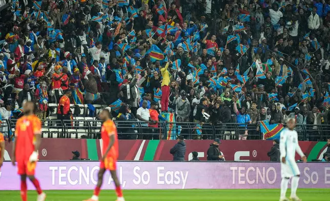 Michel Nkuka Mboladinga, a DR Congo fan impersonating late Congolese leader Patrice Lumumba, strikes a pose during the Africa Cup of Nations group D soccer match between Botswana and DR Congo in Rabat, Morocco, Tuesday, Dec. 30, 2025. (AP Photo/Mosa'ab Elshamy)