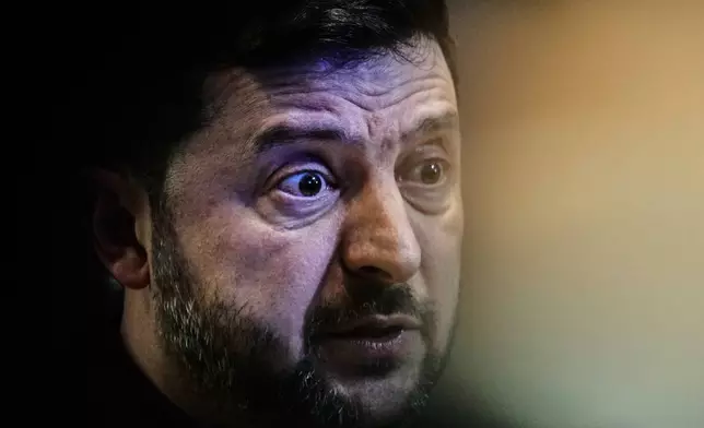 Ukraine's President Volodymyr Zelenskyy talks to the media at the Annual Meeting of the World Economic Forum in Davos, Switzerland, Thursday, Jan. 22, 2026. (AP Photo/Markus Schreiber)