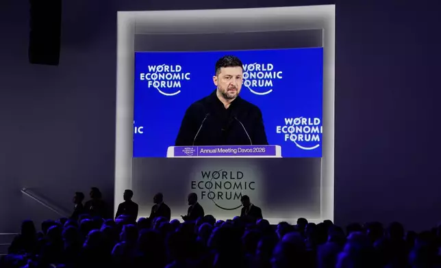 Ukraine's President Volodymyr Zelenskyy appears on a screen as he delivers a speech at the Annual Meeting of the World Economic Forum in Davos, Switzerland, Thursday, Jan. 22, 2026. (AP Photo/Markus Schreiber)