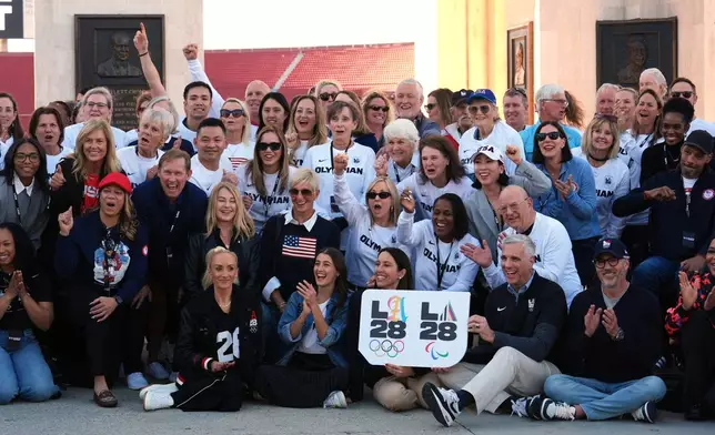 Former Olympians gather for a group photo at the Los Angeles Memorial Coliseum ahead of the launch for ticket registration to the 2028 Summer Olympic Games Tuesday, Jan. 13, 2026, in Los Angeles. (AP Photo/Damian Dovarganes)