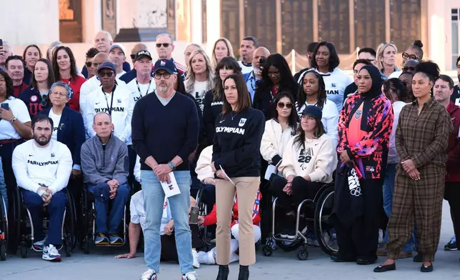 Former Olympian Jane Evans, LA28 Chief Athlete Officer, center right, stands next to Casey Wasserman, LA28 Chairperson and President, at the Los Angeles Memorial Coliseum ahead of the launch for ticket registration to the 2028 Summer Olympic Games Tuesday, Jan. 13, 2026, in Los Angeles. (AP Photo/Damian Dovarganes)