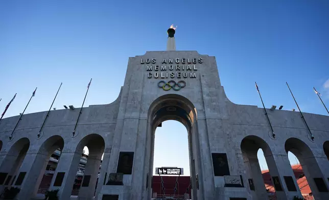 The Olympic cauldron is lit at the Los Angeles Memorial Coliseum ahead of the launch for ticket registration to the 2028 Summer Olympic Games Tuesday, Jan. 13, 2026, in Los Angeles. (AP Photo/Damian Dovarganes)