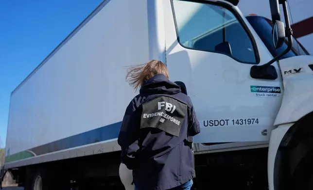 FBI officers are seen at the Fulton County Election Hub and Operation Center, Wednesday, Jan. 28, 2026, in Union City, Ga, near Atlanta. (AP Photo/Mike Stewart)
