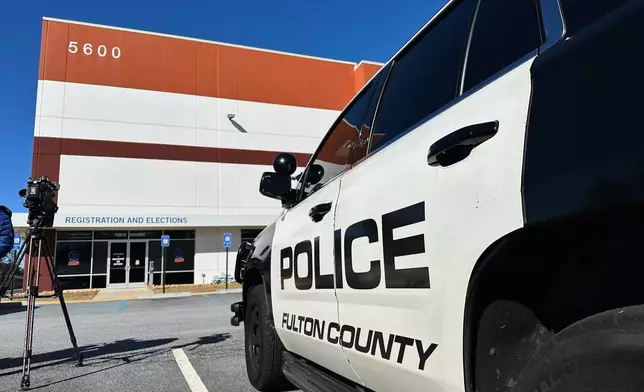 Police vehicles are seen outside the Fulton County elections hub in Union City, Ga., Wednesday, Jan. 28, 2026. (AP Photo/Emilie Megnien)