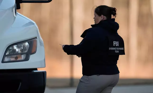 FBI officers are seen at the Fulton County Election Hub and Operation Center, Wednesday, Jan. 28, 2026, in Union City, Ga, near Atlanta. (AP Photo/Mike Stewart)