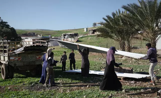 Palestinian residents of Ras Ein al-Auja village, West Bank pack up their belongings and prepare to leave their homes after deciding to flee mounting settler violence, Sunday, Jan. 11, 2026. (AP Photo/Mahmoud Illean)