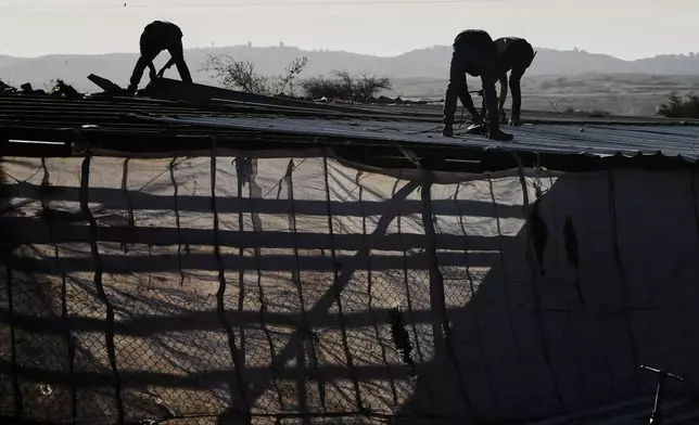 Palestinian residents of Ras Ein al-Auja village, West Bank pack up their belongings and prepare to leave their homes after deciding to flee mounting settler violence, Sunday, Jan. 11, 2026. (AP Photo/Mahmoud Illean)