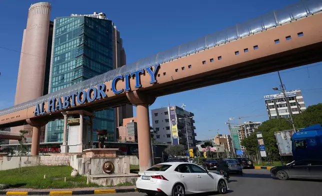Cars pass next to Habtoor hotel, left, in Beirut, Lebanon, Monday, Jan. 26, 2026. (AP Photo/Hassan Ammar)