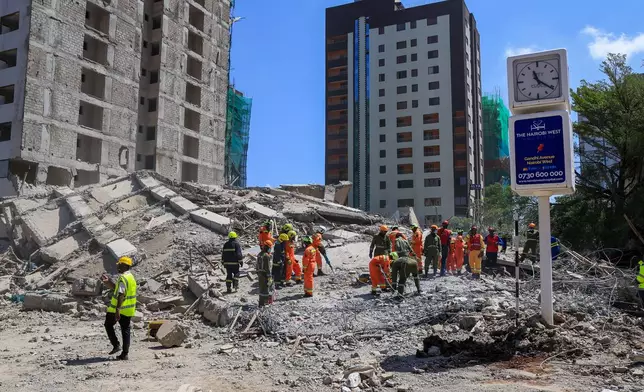 A rescue team works at the scene of a collapsed building in Nairobi, Kenya, Friday, Jan. 2, 2026. (AP Photo/Andrew Kasuku)