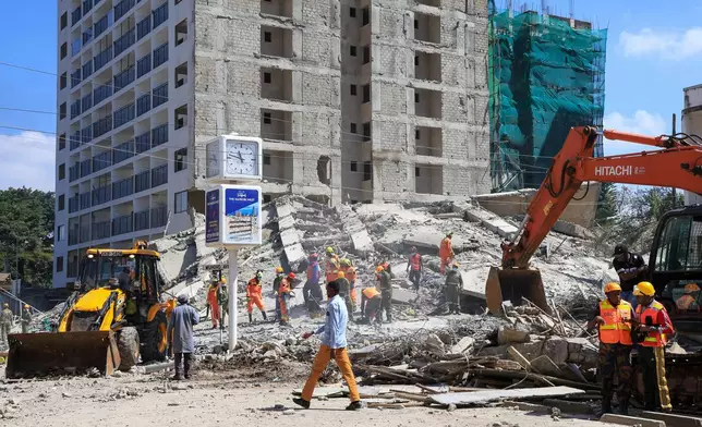 A rescue team works at the scene of a collapsed building in Nairobi, Kenya, Friday, Jan. 2, 2026. (AP Photo/Andrew Kasuku)