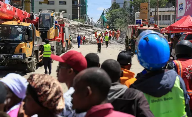 A rescue team works at the scene of a collapsed building in Nairobi, Kenya, Friday, Jan. 2, 2026. (AP Photo/Andrew Kasuku)