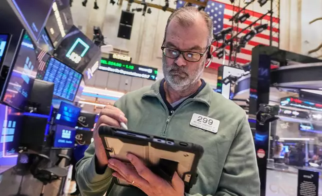 Trader William Lawrence works on the floor of the New York Stock Exchange, Monday, Jan. 26, 2026. (AP Photo/Richard Drew)