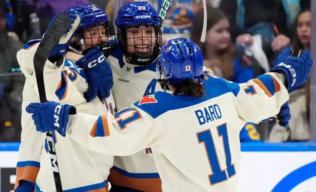 Vancouver Goldeneyes forward Sarah Nurse (20) celebrates after her goal with teammates Michelle Karvinen (33) and Sydney Bard (11) during second-period PWHL hockey game action against the Toronto Sceptres in Toronto, Saturday, Jan. 17, 2026. (Frank Gunn/The Canadian Press via AP)