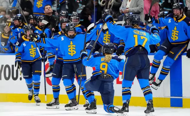 Toronto Sceptres forward Daryl Watts (9) celebrates her game-winning goal with teammates at the end of overtime period PWHL hockey action against the Vancouver Goldeneyes, in Toronto, Saturday, Jan. 17, 2026. (Frank Gunn/The Canadian Press via AP)