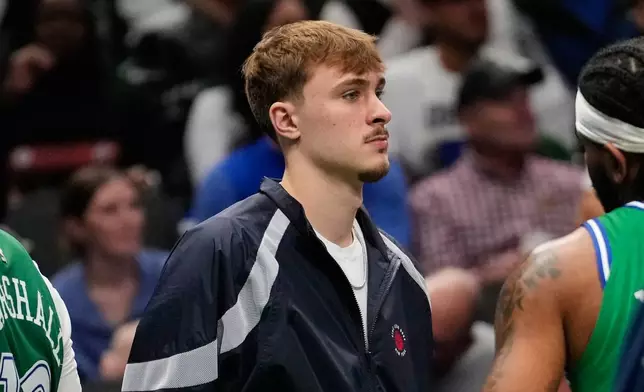 Dallas Mavericks' Cooper Flagg stands by the bench in the second half of an NBA basketball game against the Minnesota Timberwolves Wednesday, Jan. 28, 2026, in Dallas. (AP Photo/Tony Gutierrez)