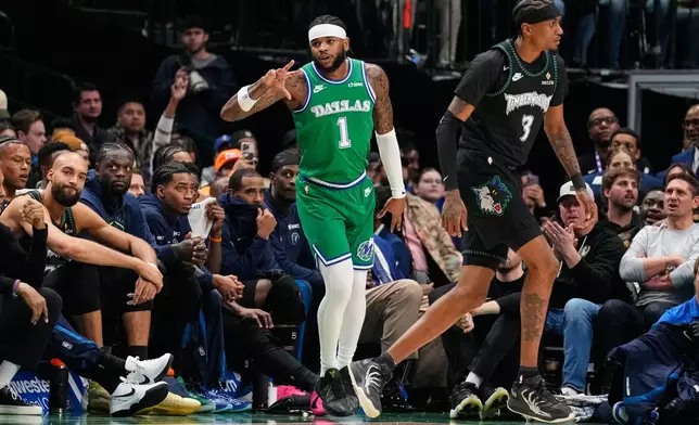 Dallas Mavericks' Jaden Hardy (1) celebrates his three-pointer in front of Minnesota Timberwolves forward Jaden McDaniels (3) in the first half of an NBA basketball game Wednesday, Jan. 28, 2026, in Dallas. (AP Photo/Tony Gutierrez)