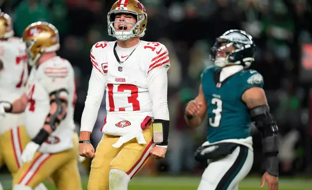 San Francisco 49ers quarterback Brock Purdy (13) reacts to a touchdown pass to 49ers running back Christian McCaffrey during the second half of an NFL wild-card playoff football game against the Philadelphia Eagles on Sunday, Jan. 11, 2026, in Philadelphia. (AP Photo/Chris Szagola)