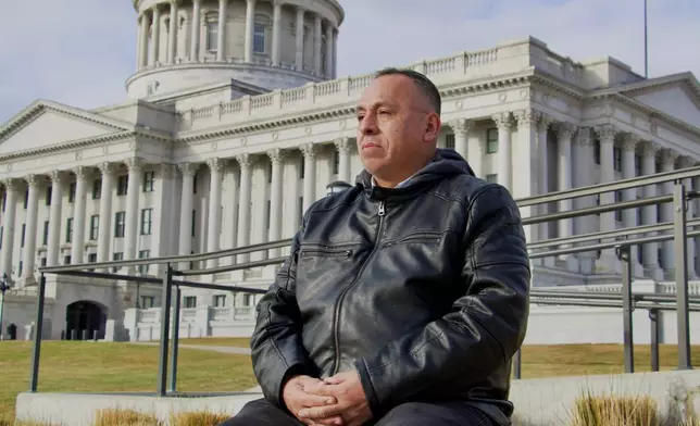 Manuel Coronel, a 54-year-old lawyer who left Venezuela in 2017 and eventually settled in Utah, sits for a portrait in front of the state's Capitol Building in Salt Lake City, Friday, Jan. 9, 2026. (AP Photo/Hannah Schoenbaum)