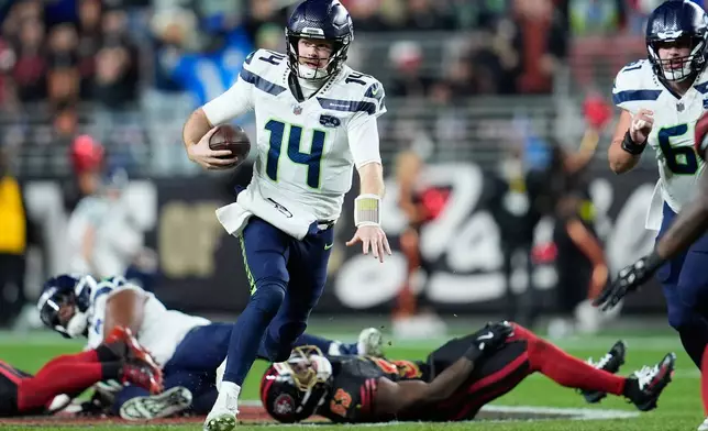 Seattle Seahawks quarterback Sam Darnold (14) runs against the San Francisco 49ers during the first half of an NFL football game in Santa Clara, Calif., Saturday, Jan. 3, 2026. (AP Photo/Godofredo A. Vásquez)