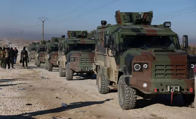 Syrian government forces in armored vehicles enter the al-Hol camp in northeastern Syria's Hasakeh province, Syria, Wednesday, Jan. 21, 2026, after the withdrawal of the Syrian Democratic Forces (SDF). (AP Photo/Ghaith Alsayed)