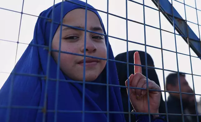 Sundus al-Hassan, 10, poses for a picture inside the al-Hol camp in northeastern Syria's Hasakeh province, Syria, Wednesday, Jan. 21, 2026, after the withdrawal of the Syrian Democratic Forces (SDF). (AP Photo/Ghaith Alsayed)