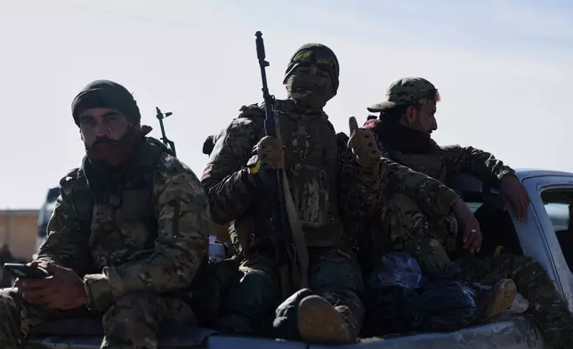 Syrian government soldiers sit atop a vehicle as they patrol inside the al-Hol camp in northeastern Syria's Hasakeh province, Syria, Wednesday, Jan. 21, 2026, after the withdrawal of the Syrian Democratic Forces (SDF). (AP Photo/Ghaith Alsayed)