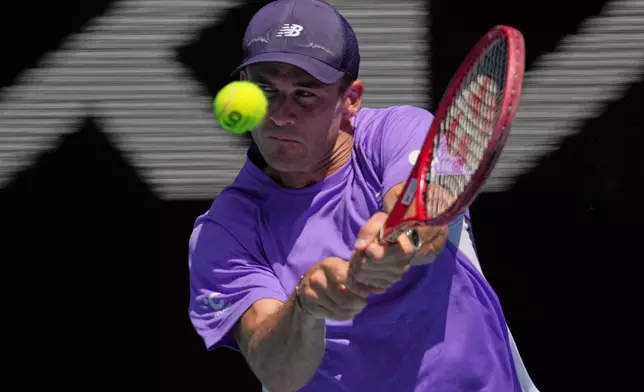Tommy Paul of the U.S. plays a backhand return to Carlos Alcaraz of Spain during their fourth round match at the Australian Open tennis championship in Melbourne, Australia, Sunday, Jan. 25, 2026. (AP Photo/Dita Alangkara)